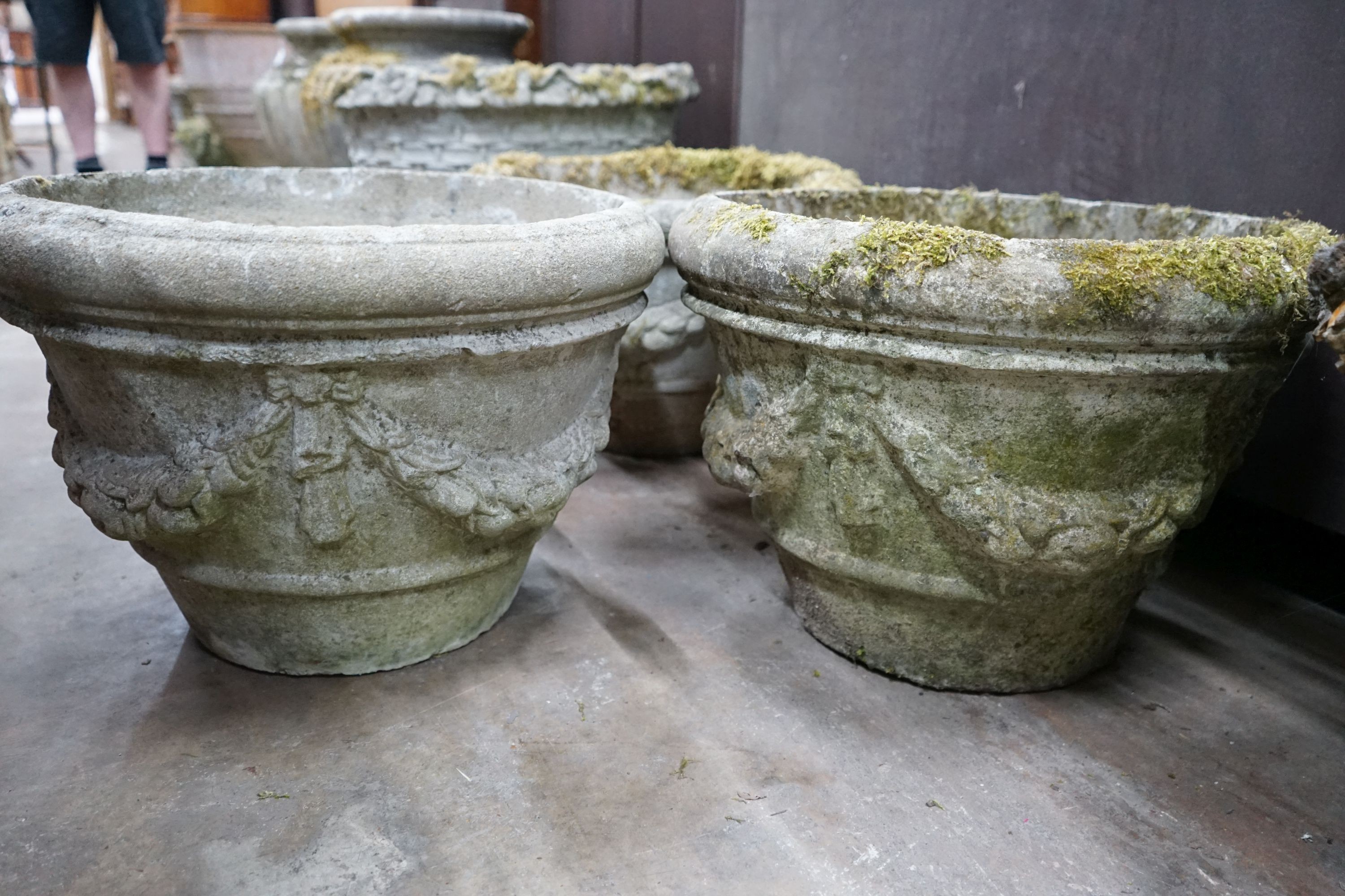 A set of three circular reconstituted stone garden planters with swagged bodies, diameter 48cm, height 32cm